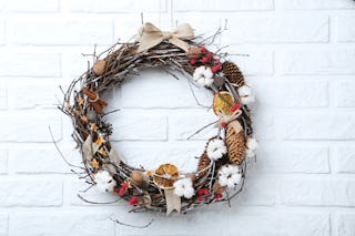 Wreaths of dried wood, fruits and pine cones are a popular alternative to the classic greenery.