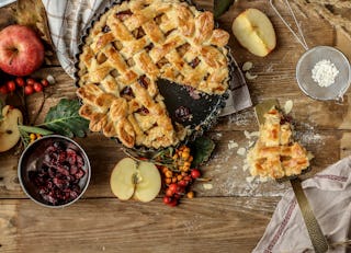 A slice of Christmas apple pie with cranberries brightens everyone