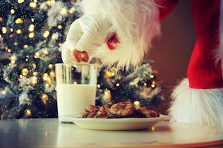 Santa partaking in some milk and cookies.